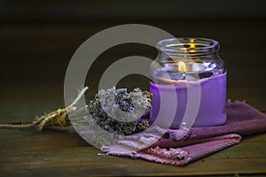 Glass bottle Lavender essential oil dried seed aromatherapy spa massage concept. herb Purple candle wood table background sea