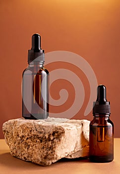 Glass bottle with moisturizing oil on  brown background.  Natural cosmetics  concept