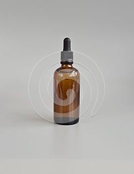 Glass bottle with oil for cosmetic product packaging mockup photo