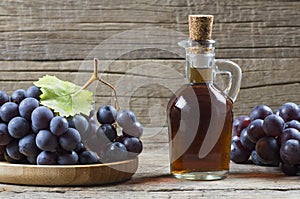 Glass bottle of organic black grape balsamic vinegar made from fermented fresh grapes