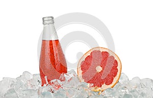 Glass bottle of pink grapefruit drink on ice