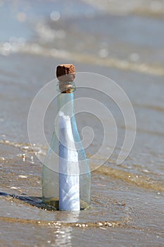 glass bottle with a secret message by the sea