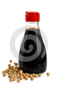 Glass bottle of soya sauce with red plastic lid isolated on whit photo