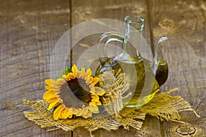 Glass bottle with sunflower oil and sunflowers