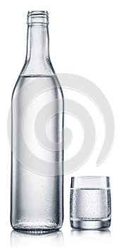 Glass and bottle of vodka, chilled alcohol drink, on white background. Clipping path