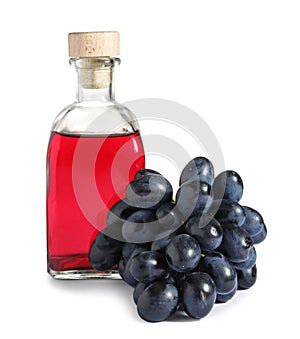 Glass bottle with wine vinegar and fresh grapes