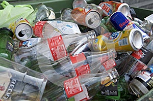 Glass bottles and aluminum cans pile photo