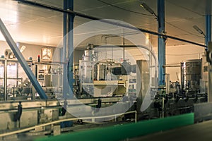 Glass bottles on the automatic conveyor line at the champagne, beer or wine factory