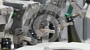 Glass bottles on the automatic conveyor line at the champagne or wine factory. Plant for bottling alcoholic beverages.