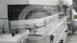 Glass bottles on the automatic conveyor line at the champagne or wine factory. Plant for bottling alcoholic beverages.