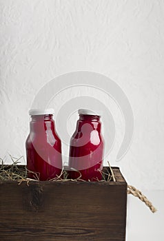 Glass bottles with beet detox smoothie or fresh vegetables