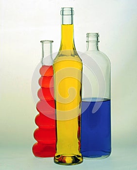 glass bottles filled with colored liquids