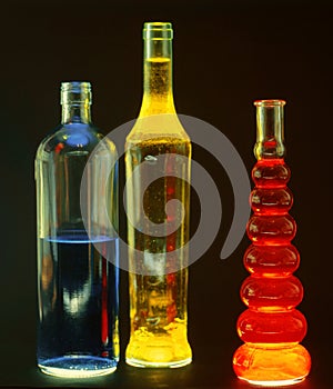 glass bottles filled with colored liquids