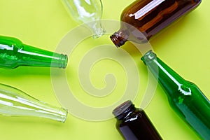 Glass bottles on green background