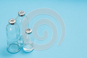 Glass bottles for liquid medicine on a blue background