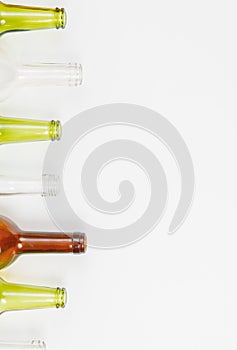 Glass bottles of mixed colors including green, clear white, brow