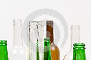 Glass bottles of mixed colors including green, clear white, brow