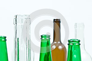 Glass bottles of mixed colors including green, clear white, brow