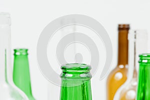 Glass bottles of mixed colors including green, clear white, brow