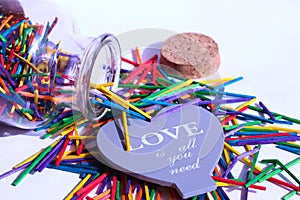 Opend glass bottle with multicolor wood sticks outside photo