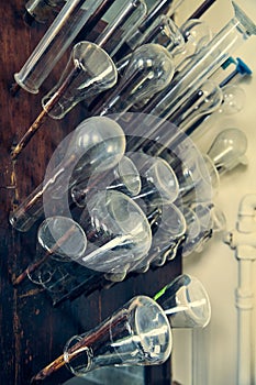 Glass bottles, test tubes, flasks and cups in an old chemical laboratory