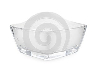 Glass bowl with baking soda isolated on white