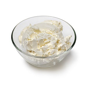 Glass bowl with clotted cream close up on white background