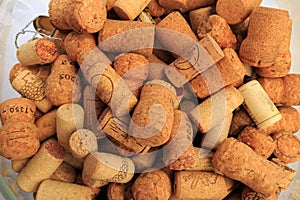 A glass bowl containing a multitude of wine corks - Image