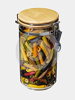 Glass bowl filled with colored pasta on white background