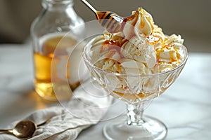 A glass bowl filled with delicious ice cream scoops and drizzled with golden honey, tempting your tastebuds, Simple honey sundae