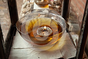 A glass bowl filled with oil to kindle a memorial at a Jewish gravesite in Jerusalem
