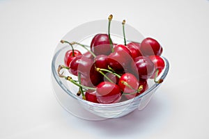 The glass bowl filled with ripe cherries