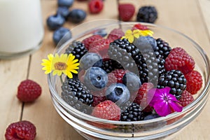 Glass bowl of fresh blackberries, raspberries, blueberries