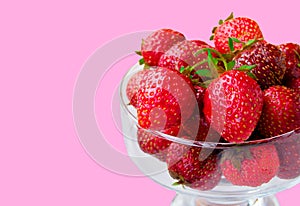 Glass bowl with fresh ripe strawberries, space for text, copy space isolated on pink background, layout, clipping