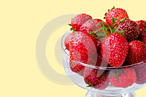 Glass bowl with fresh ripe strawberries, space for text, copy space isolated on yellow background, layout, clipping