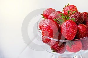 Glass bowl with fresh ripe strawberries, space for text, copy space, white background, mockup