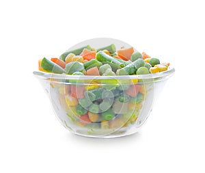 Glass bowl with frozen vegetables on white background