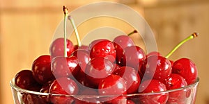 Glass bowl full of red ripe cherries