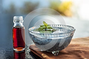 Glass bowl full of soaked sabja seeds or falooda seeds or sweet basil seeds with its extracted essence or essential oil in a trans