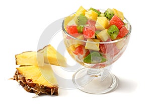 Glass bowl of healthy citrus fruit salad isolated on white background