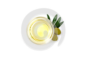 Glass bowl with olive oil, olives and leafs. Close-up, isolated on white background