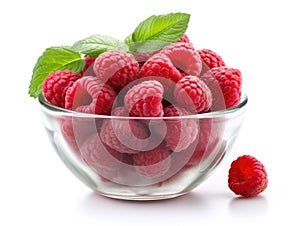 Glass bowl with raspberries and green leaves