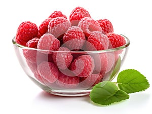 Glass bowl with raspberries and green leaves