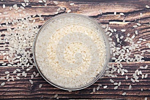A glass bowl with raw round rice