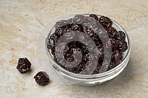 Glass bowl with red dried cherries close up