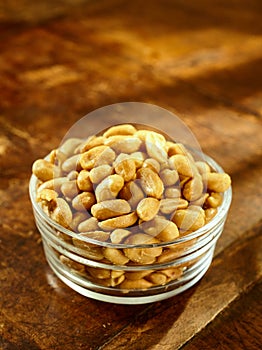 Glass bowl of roasted peanuts or groundnuts