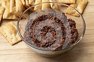 Glass bowl with traditional homemade black olive tapenade photo