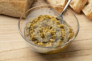 Glass bowl with traditional homemade green olive tapenade photo