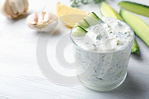 Glass bowl of Tzatziki cucumber sauce with ingredients