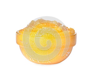 Glass bowl of yellow body scrub isolated on white